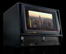 A dark gray video monitor displaying a cityscape with skyline buildings against a sunset sky.