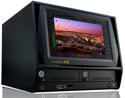 A black Cinedeck RX video playback device displaying a landscape scene on its screen.