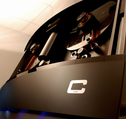 Low angle view of a dark, sleek piece of industrial machinery with a white logo on a curved front panel.