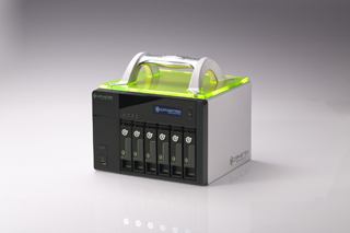 A black and silver electronic device with a translucent green top and four vertical slots on the front.
