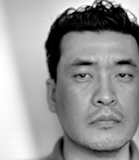 Close-up of a man's face in black and white.