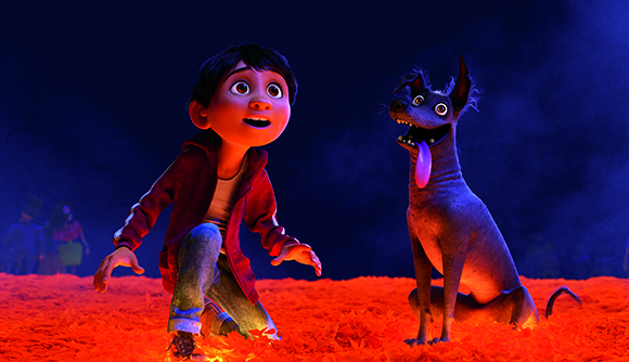 Animated boy in a red jacket and a large grey dog sit on a bed of orange marigold petals.