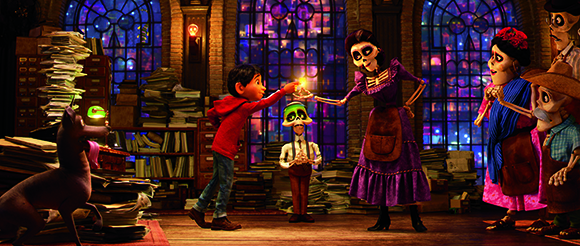 A boy in red presents a glowing photograph to a tall skeletal woman in a purple dress amidst stacks of paper.