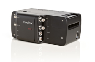 A black Codex electronic device with multiple silver input and output ports on its side.