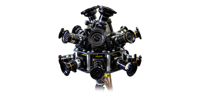 A complex camera rig featuring multiple lenses arranged in a circular, spherical configuration.