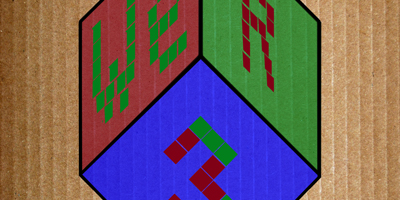 A large hexagon divided into red, green, and blue sections with pixelated green and red patterns.