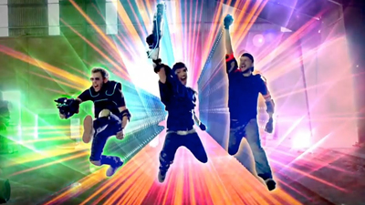 Three people jumping mid-air against a background of radiating colorful light beams.