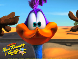 A close-up 3D animation of the Road Runner character with large eyes and an orange beak against a desert background.