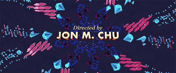Title card reading 'Directed by JON M. CHU' surrounded by exploding blue and pink crystals.