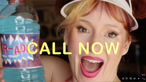 A woman with red hair and a white visor holds a blue liquid bottle with yellow text reading 'CALL NOW'.