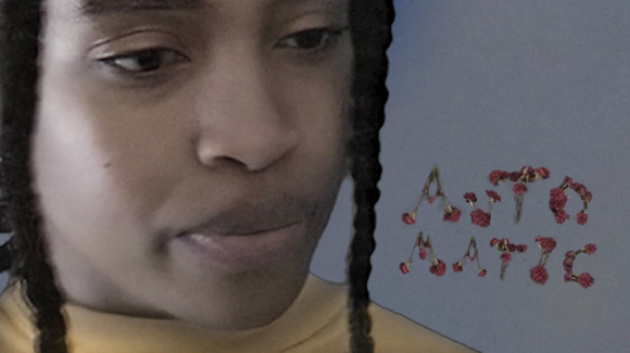 Close-up of a person with braided hair looking downward next to the word AUTOMATIC in pink floral letters.