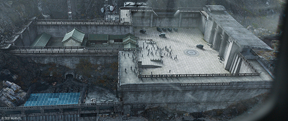 Aerial view of a massive concrete fortress complex with traditional buildings and a large courtyard.