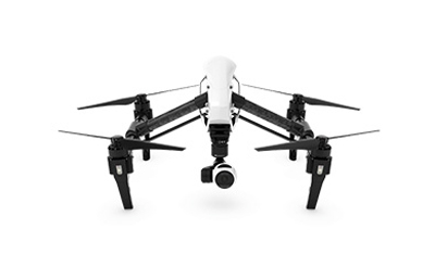 A white and black quadcopter drone with four rotors and a camera mounted underneath on a white background.