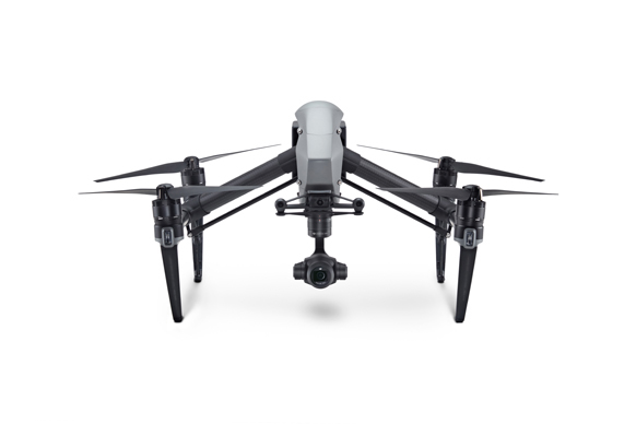 A black and white quadcopter drone with four rotors and a central camera gimbal against a white background.