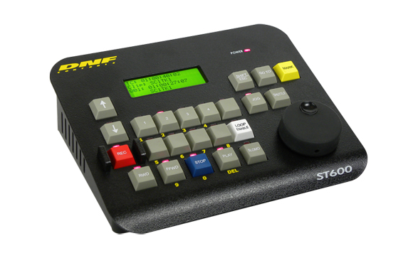 Black DNEG ST600 control panel with a green screen, colorful buttons, and a large black jog dial.