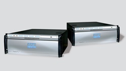 Two rectangular silver and black server units positioned on a gray surface.