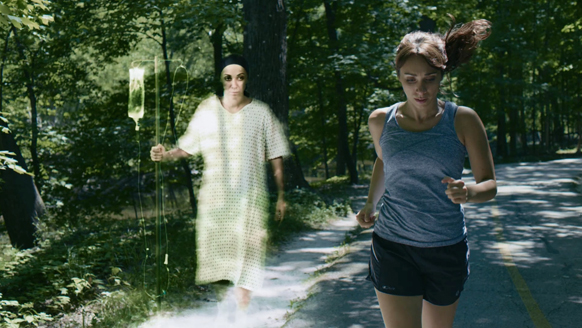 A woman in athletic wear runs on a paved path next to a translucent figure in a hospital gown.
