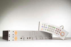A silver rack-mounted audio processor and a matching curved control panel with various buttons and knobs.