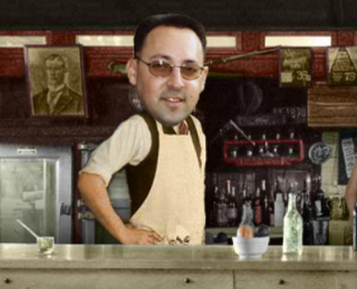 A man with glasses and a pasted-on head wears an apron and stands behind a bar with bottles and a framed picture.
