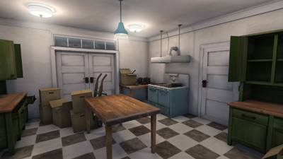 A kitchen with green cabinets, a wooden table, cardboard boxes, and a checkered floor.