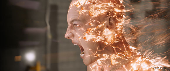 A man's profile as his skin and head dissolve into glowing orange embers and dust.