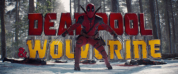 Deadpool in a red suit stands in a snowy forest before large yellow and red movie title text.