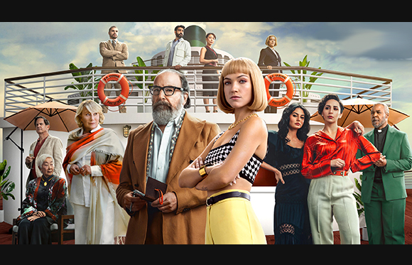 A diverse group of people in stylish clothing posing on a multi-level cruise ship deck under a cloudy sky.