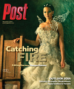 Jennifer Lawrence in a white, elaborate gown and headpiece, holding a small flower, with the words "Catching Fire" and "Post"