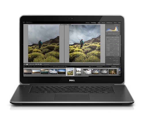 A Dell laptop open on a white background, showing a photo editing interface with landscape images.