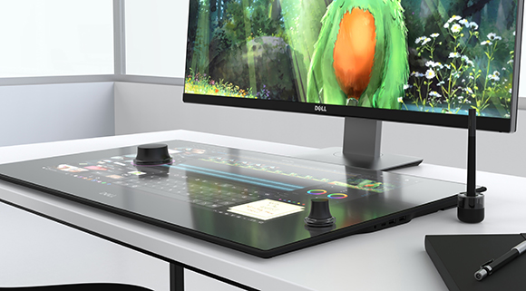 A Dell monitor and a large glass touch-surface controller with two control knobs on a white desk.