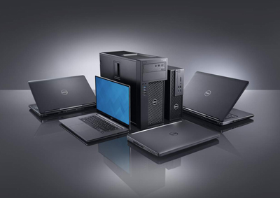 Various Dell laptops and black desktop computer towers arranged on a reflective dark surface.