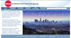 Deluxe Entertainment Services Group website with a Los Angeles cityscape background.