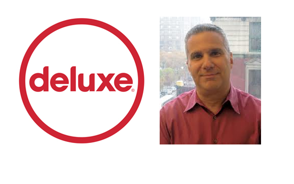 The red Deluxe logo next to a portrait of a man in a maroon shirt.