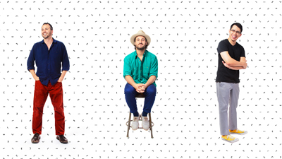 Three men standing and sitting against a white background with small black dash patterns.