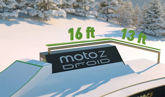 A snow-covered ramp featuring 'motoZ DROID' text and green '16 ft' and '13 ft' height labels.