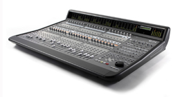 A large grey digital audio mixing console with numerous faders, knobs, and a display screen.