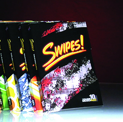 A stack of colorful books titled 'Swipes!' with vibrant, abstract cover designs.