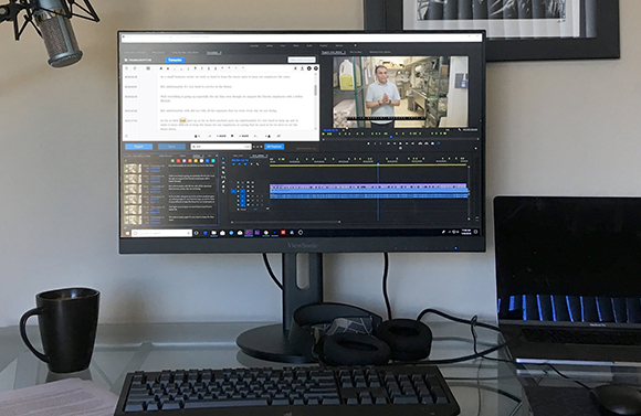 A ViewSonic monitor showing a video editing timeline and a video clip of a man in a white shirt.
