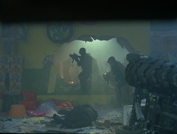 Silhouetted figures move through a smoke-filled room with a large breach in the wall.