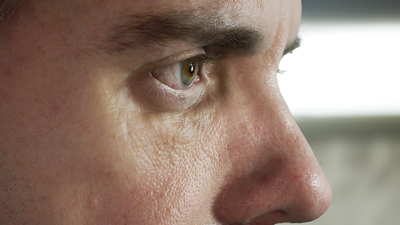 Extreme close-up of a man's eye, eyebrow, and nose in profile.