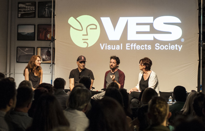 Four people sit on a stage in front of a screen with the VES logo and text that reads "Visual Effects Society".