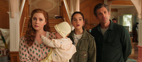 A woman in a floral shirt, a baby in a white hat, a young woman in a green jacket, and a man looking surprised.