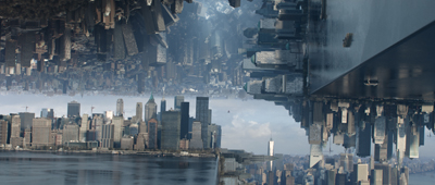 A wide shot of a city skyline with another city skyline appearing upside down above it.