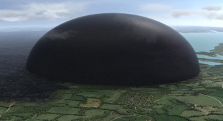 A giant, smooth black dome sits over a green landscape of fields and a body of water under a cloudy sky.