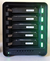 A black multi-bay external hard drive enclosure with five black drives and glowing green status lights.