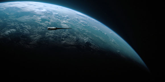 A small spacecraft flies in orbit above the curved horizon of Earth against the blackness of space.