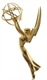 A gold winged female figure holding an atom symbol aloft.