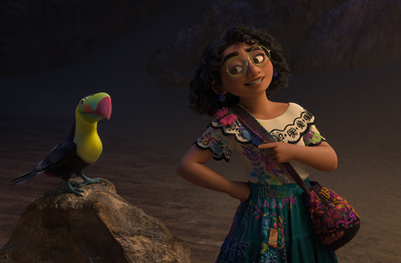 An animated girl with curly hair and glasses smiles at a colorful toucan sitting on a rock.