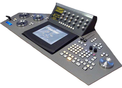 A gray electronic control console with a central screen, various buttons, knobs, and two circular dials.