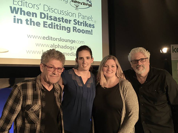 Four people stand in front of a screen with text about an editors' discussion panel on disaster in the editing room.
